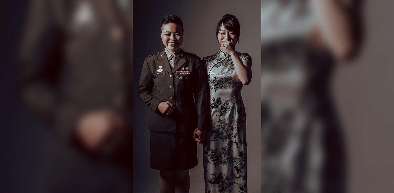 This undated and unlocated handout picture released by Taiwan’s Army Headquarters on October 27, 2020 shows a Taiwane Credit: AFP Photose soldier (L) and her partner posing for a wedding photo.