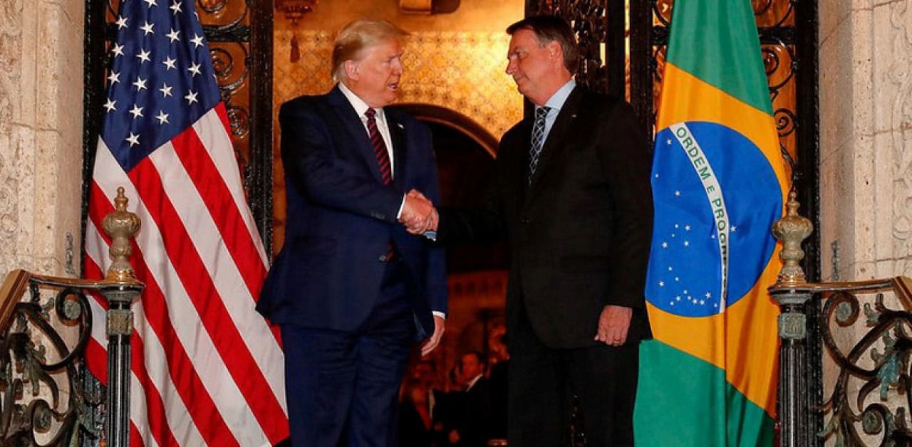US President Donald Trump shakes hands with Brazil's President Jair Bolsonaro at Mar-a-Lago residency in Palm Beach. Credit: Reuters.