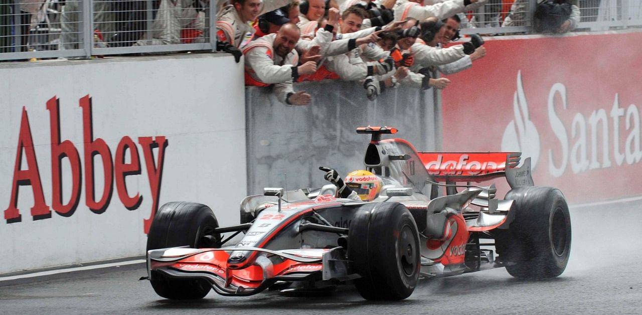 Lewis Hamilton of McLaren Mercedes celebrates winning the British Grand Prix with his pit crew. Credit: Reuters Photo