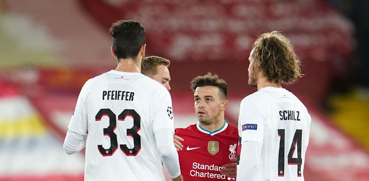 Liverpool's Swiss midfielder Xherdan Shaqiri (C) shakes hands with Midtjylland players on the pitch after during the UEFA Champions league Group D football match between Liverpool and Midtjylland. Credit: AFP Photo