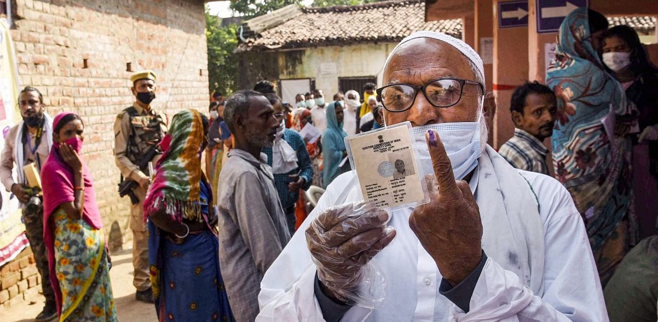 A voter shows his finger marked with indelible ink at a polling station after casting his vote for the first phase Bihar Assembly Elections, at Paliganj in Patna. Credit: PTI Photo