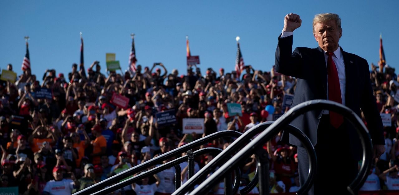 US President Donald Trump holds up his fist as he leaves after speaking during a Make America Great Again rally at Phoenix Goodyear Airport. Credit: AFP Photo