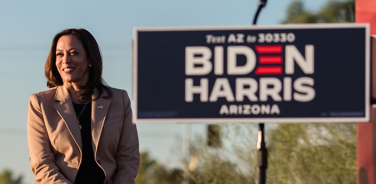 Senator from California and Democratic vice presidential nominee Kamala Harris looks on before speaking during a drive-in campaign rally in Phoenix, Arizona. Credit: AFP Photo