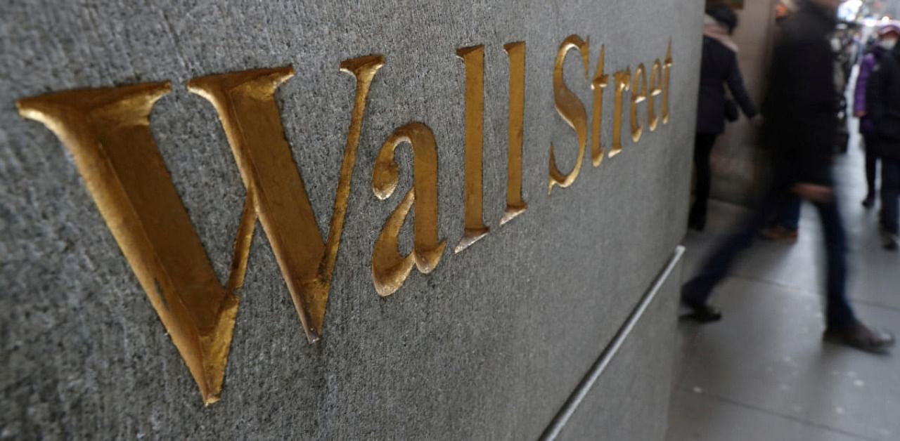 A street sign, Wall Street, is seen outside New York Stock Exchange (NYSE) in New York City. Credit: Reuters