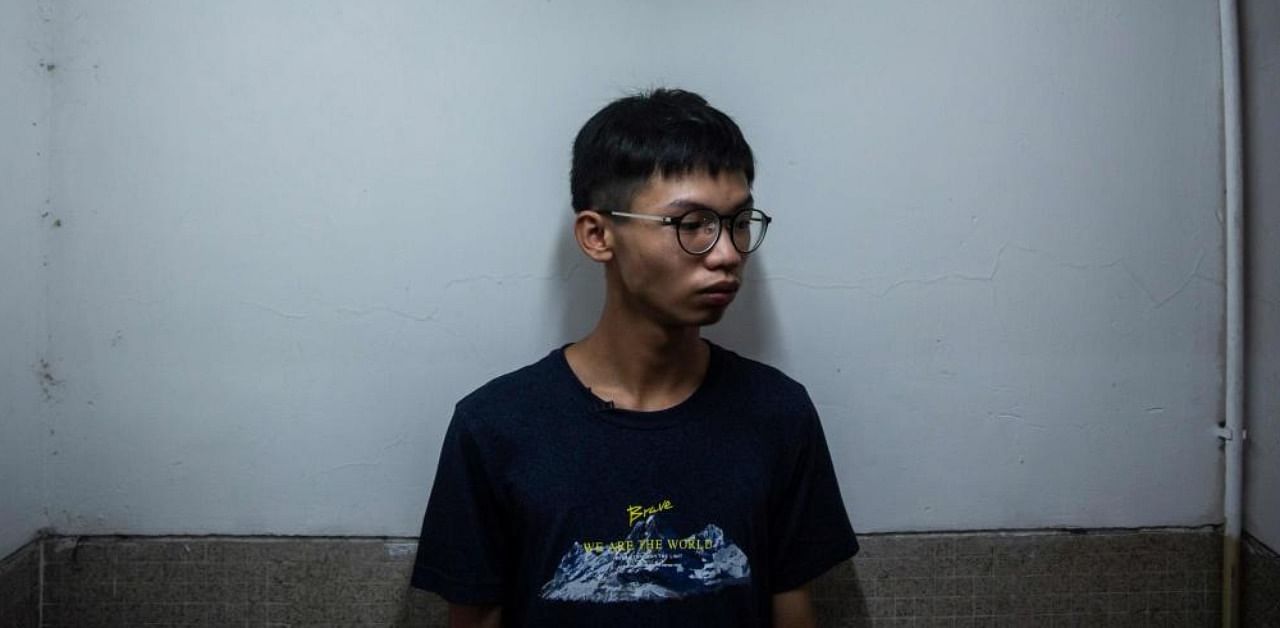 This file picture taken on August 8, 2020 shows teenager Tony Chung standing in a stairwell, where he says police for the new national security unit took him after he was detained when walking through a shopping district. Credit: AFP.