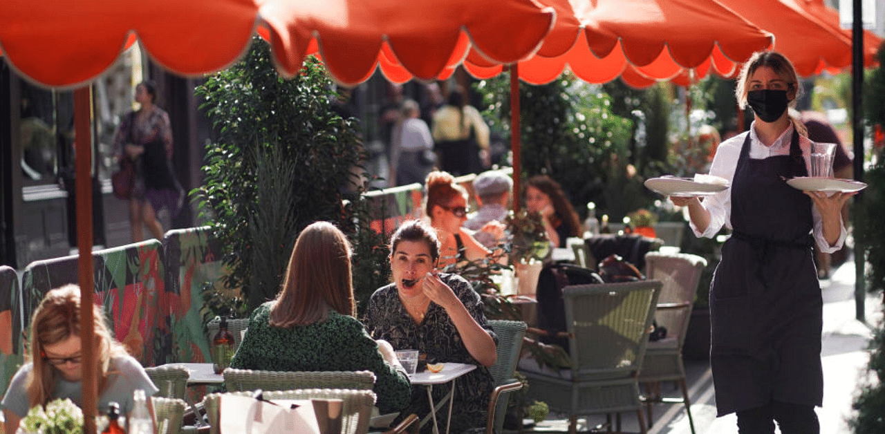 People sit at tables outside restaurants in Soho, amid the coronavirus disease (COVID-19) outbreak, in London, Britain, September 20, 2020. Credit: Reuters File Photo