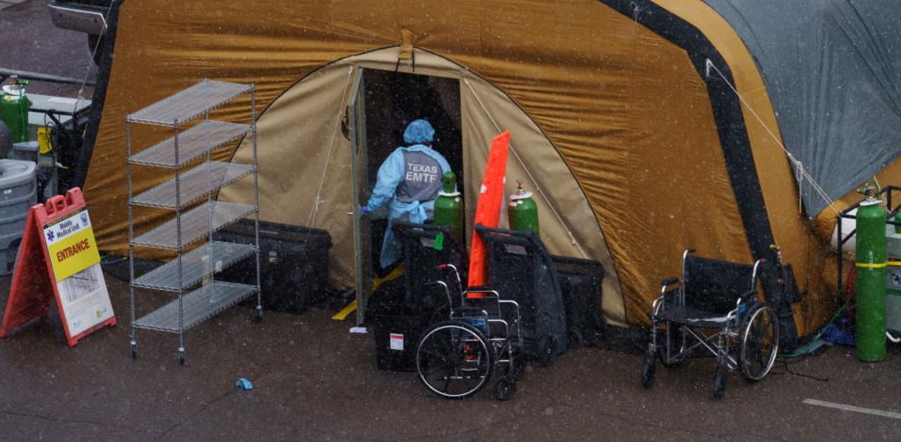  nurse is seen outside a tent set up for an overflow of Covid-19 patients at University Medical Center in El Paso. Credit: Reuters.