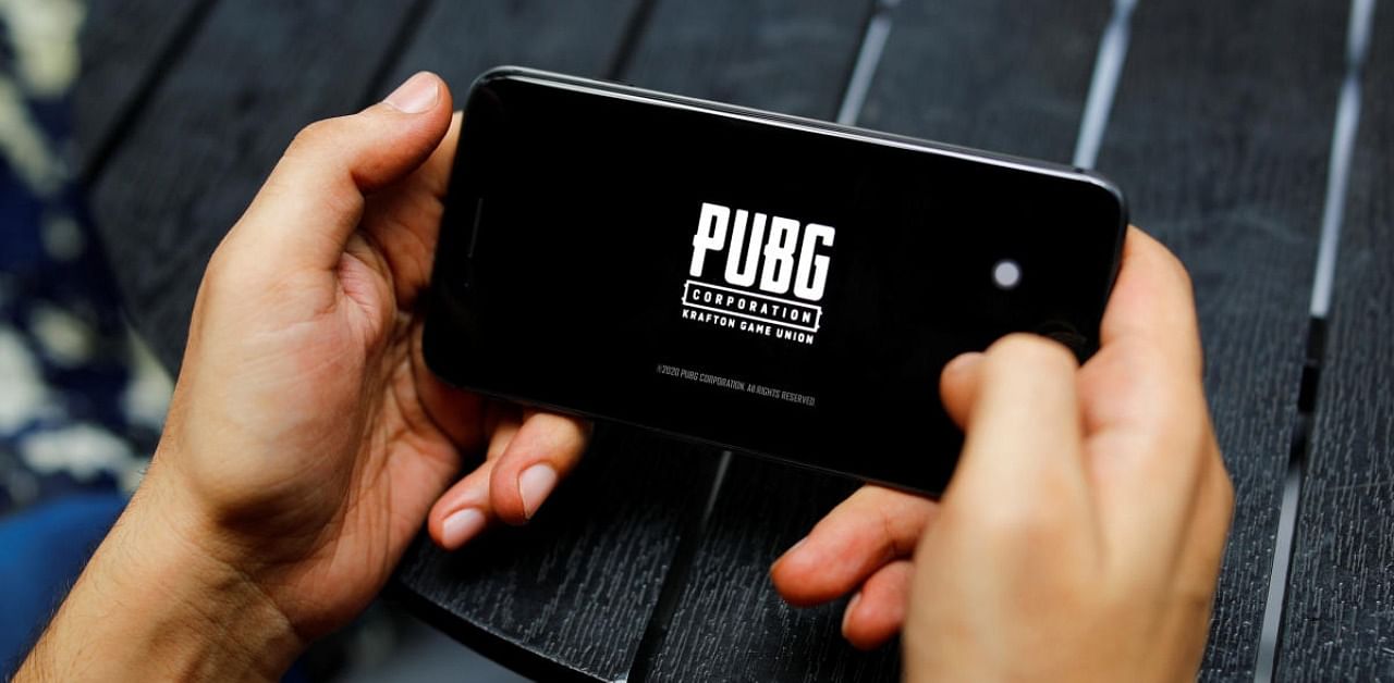 A boy plays Tencent Holdings' PUBG videogame on his mobile phone at a cafe in New Delhi, India. Credit: Reuters