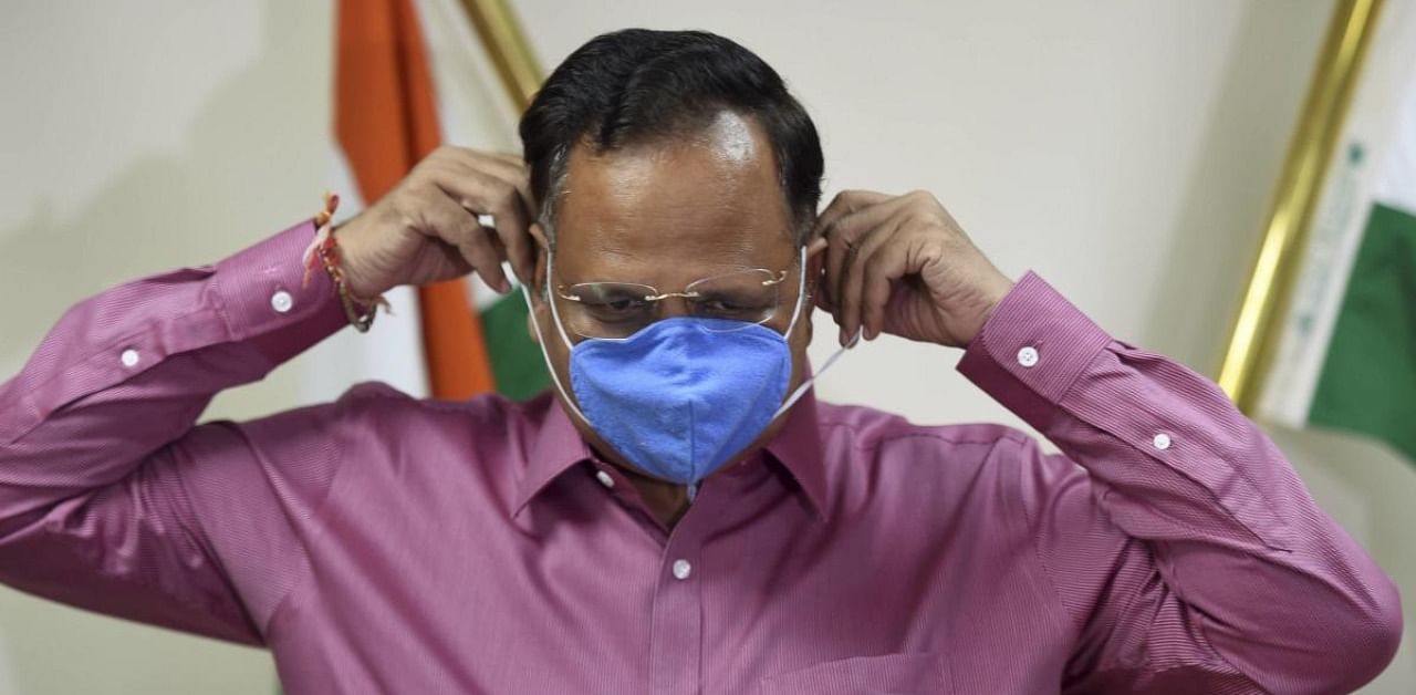 Delhi Health Minister and AAP leader Satyendar Kumar Jain wears a face mask. Credit: PTI