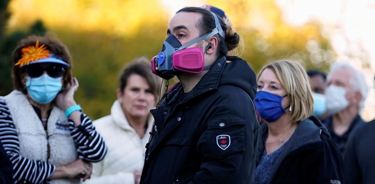 Voters wearing face masks due to the ongoing coronavirus disease (COVID-19) outbreak, wait in a nearly four hour long line to cast their ballots during early voting at a polling site in Edmond, Oklahoma. Credit: Reuters