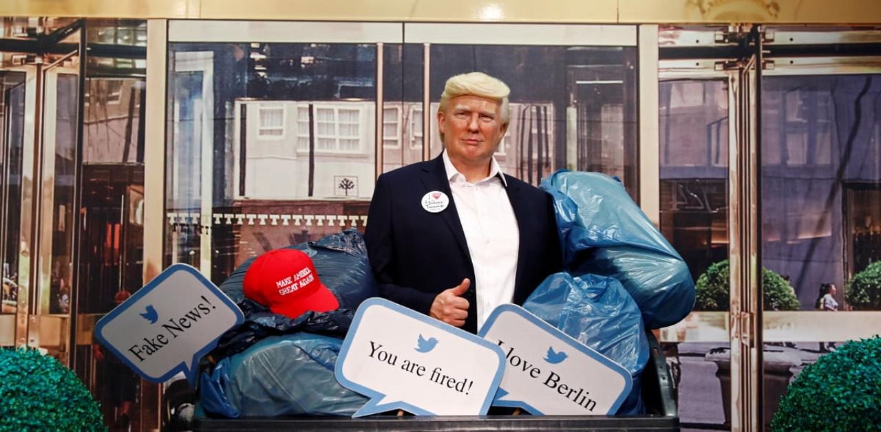 A wax figure depicting US President Donald Trump is put into a dumpster at Madame Tussauds in Berlin, Germany. Credit: Reuters
