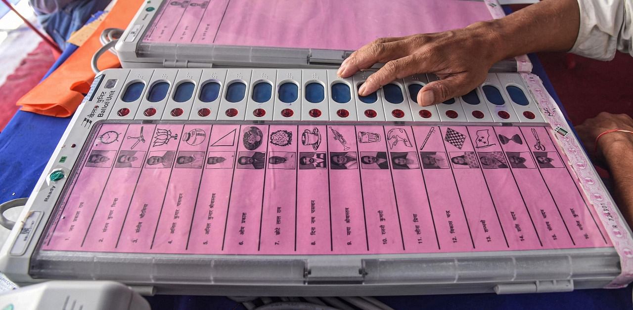 Electronic Voting Machine (EVM) sealing officers check EVMs and Voter-Verified Paper Audit Trail (VVPATs) ahead of the second phase of Bihar assembly polls, in Patna. Credit: PTI Photo