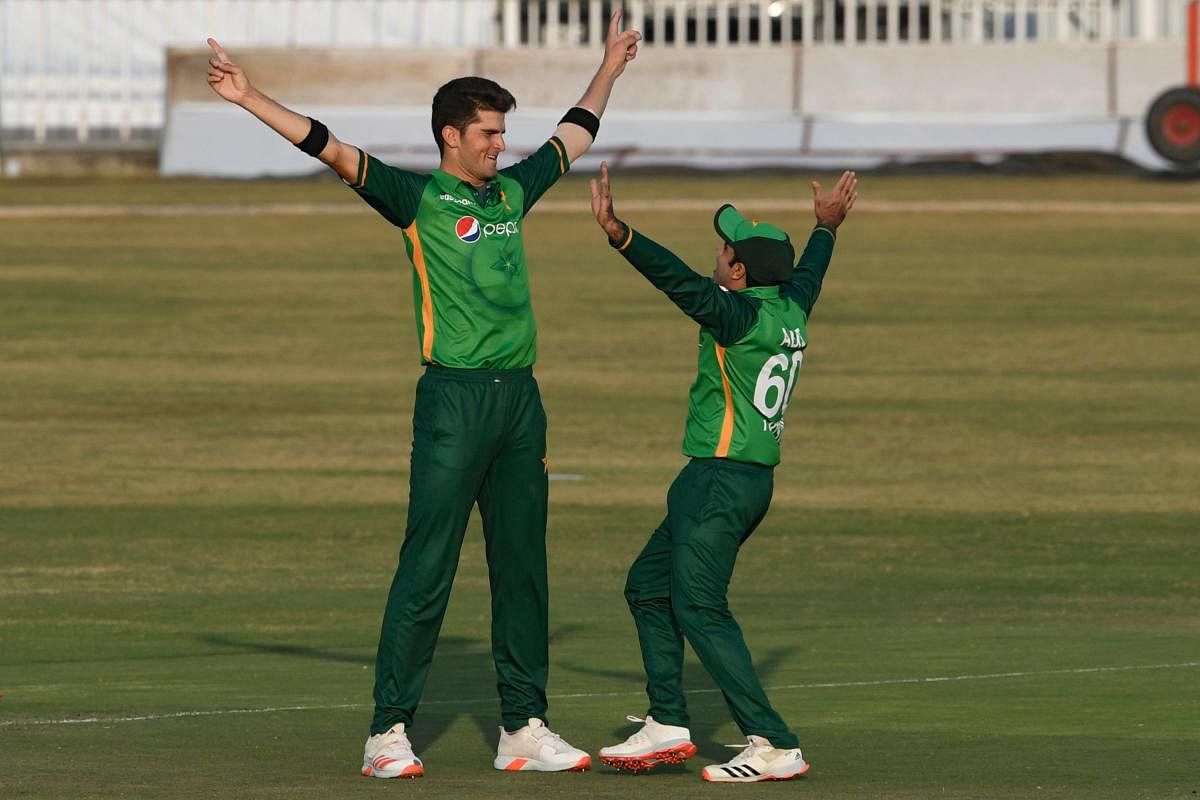 Pakistan's Shaheen Afridi (L) celebrates with teammate Abid Ali after the dismissal of Zimbabwe's Brian Chari during the first one-day international (ODI) cricket match between Pakistan and Zimbabwe at the Rawalpindi Cricket Stadium in Rawalpindi. Credit: AFP