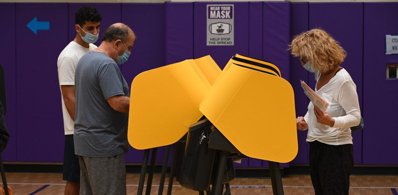 People cast their ballots for the US presidential election at Horace Mann Elementary School. Credit: AFP Photo