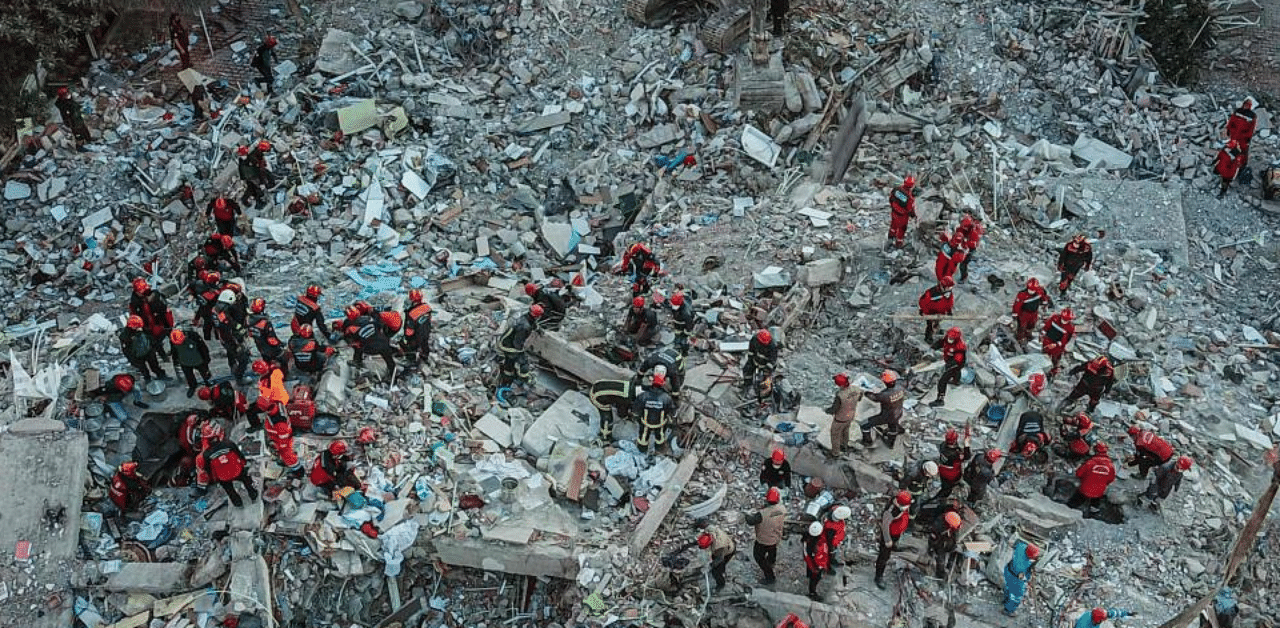 An aerial view taken on October 31, 2020, in Izmir shows Rescue workers searching for survivors in a collapsed building after a powerful earthquake struck Turkey's western coast and parts of Greece. Credit: AFP Photo