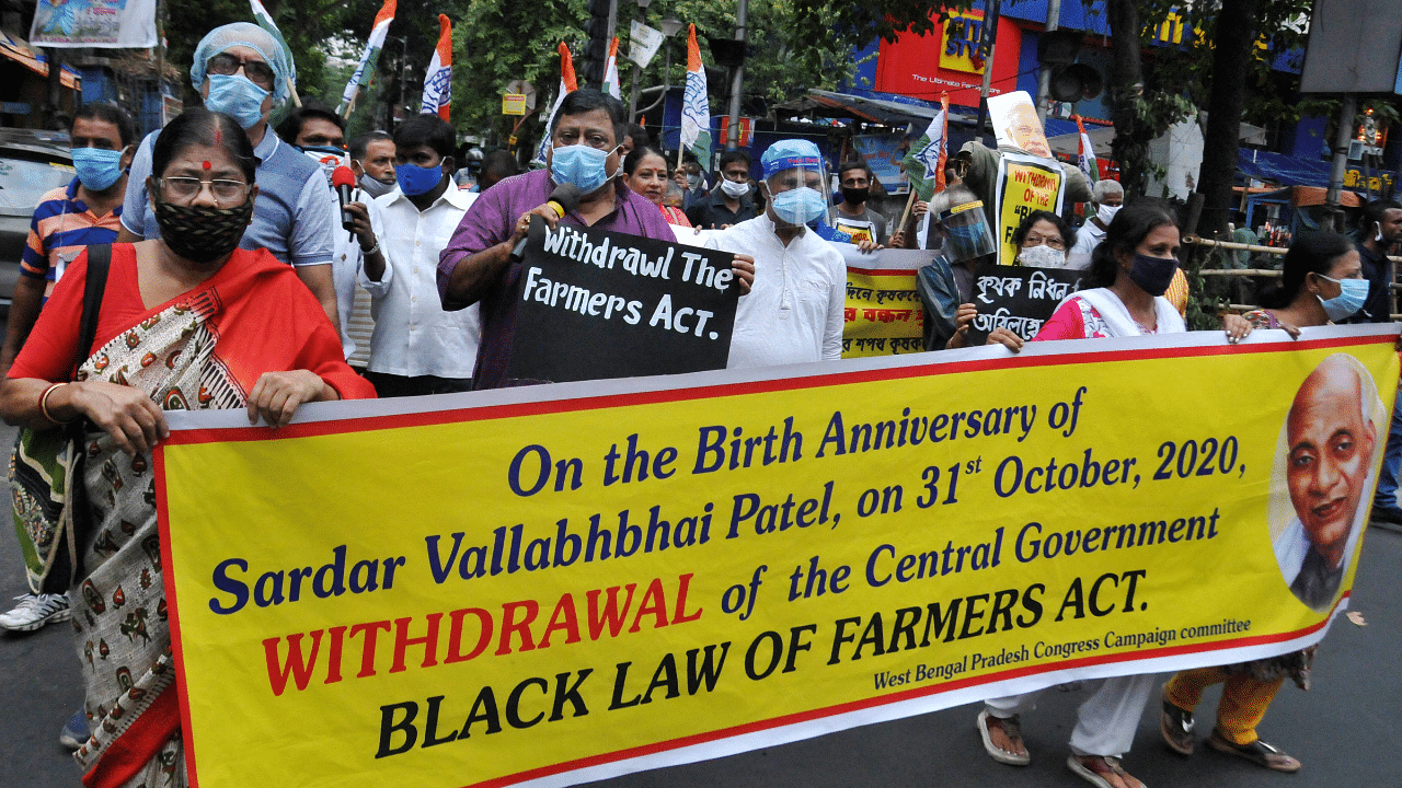 Congress Rajya Sabha MP Pradip Bhattacharjee (C) with party activists participates in a protest march against new farm laws. Credits: PTI Photo