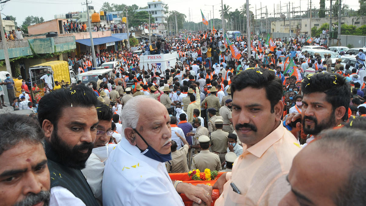 Chief Minister B S Yediyurappa takes part in a roadshow for BJP candidate from Sira constituency Dr C M Rajeshgowda in Sira town on Friday. BJP state vice president B Y Vijayendra, minister Sriramulu and MPs Pratap Simha and S Muniswamy are seen. DH PHOTO