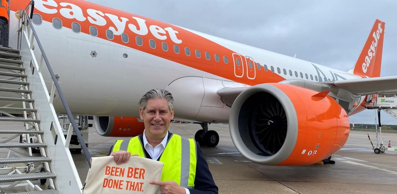 EasyJet CEO Johan Lundgren poses in front of an aircraft holding a bag with the words "BEEN BER - DONE THAT" before boarding a flight to new Berlin-Brandenburg Airport (BER) in Schoenefeld, taking off from Berlin Tegel (TXL) airport in Berlin. Credit: Reuters