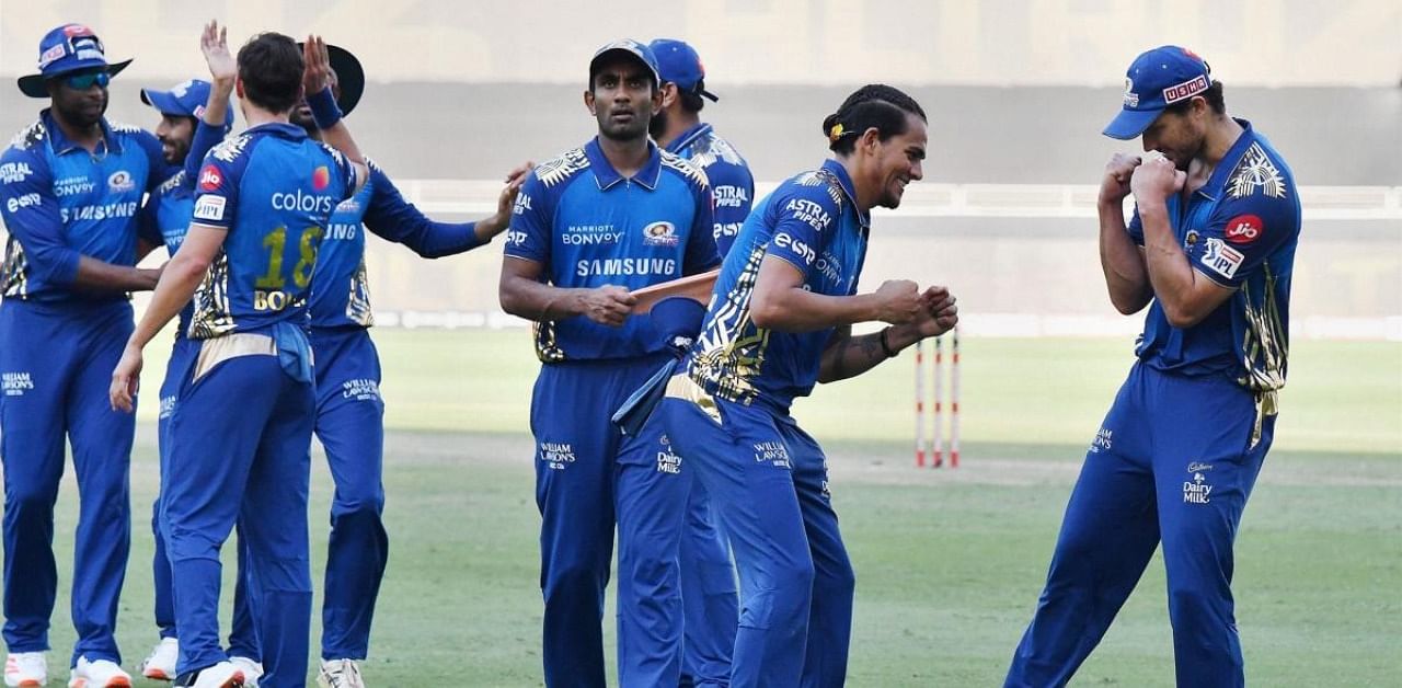 Mumbai Indians (MI) players Rahul Chahar and Nathan Coulter-Nile celebrate after winning the match against Delhi Capitals during the Indian Premier League (IPL) T20, at Dubai International Cricket Stadium in Dubai. Credit: PTI