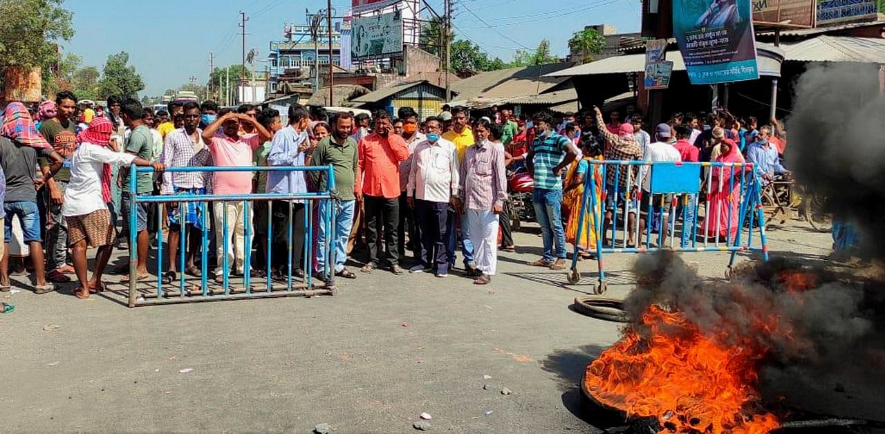 BJP supporters block a road in protest against the death of a party supporter in the police lockup, in Birbhum district of West Bengal. Credit: PTI Photo