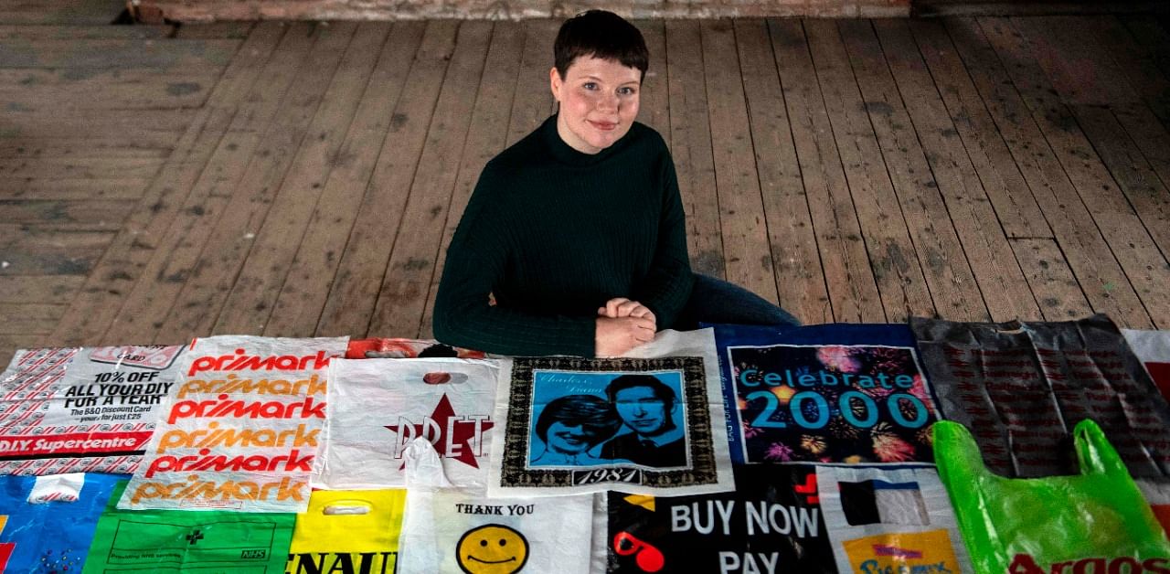 British artist Katrina Cobain, 24, poses for photographs with some of her collection of plastic bags from which she intends to start The Plastic Bag Museum in Glasgow. Credit: AFP Photo