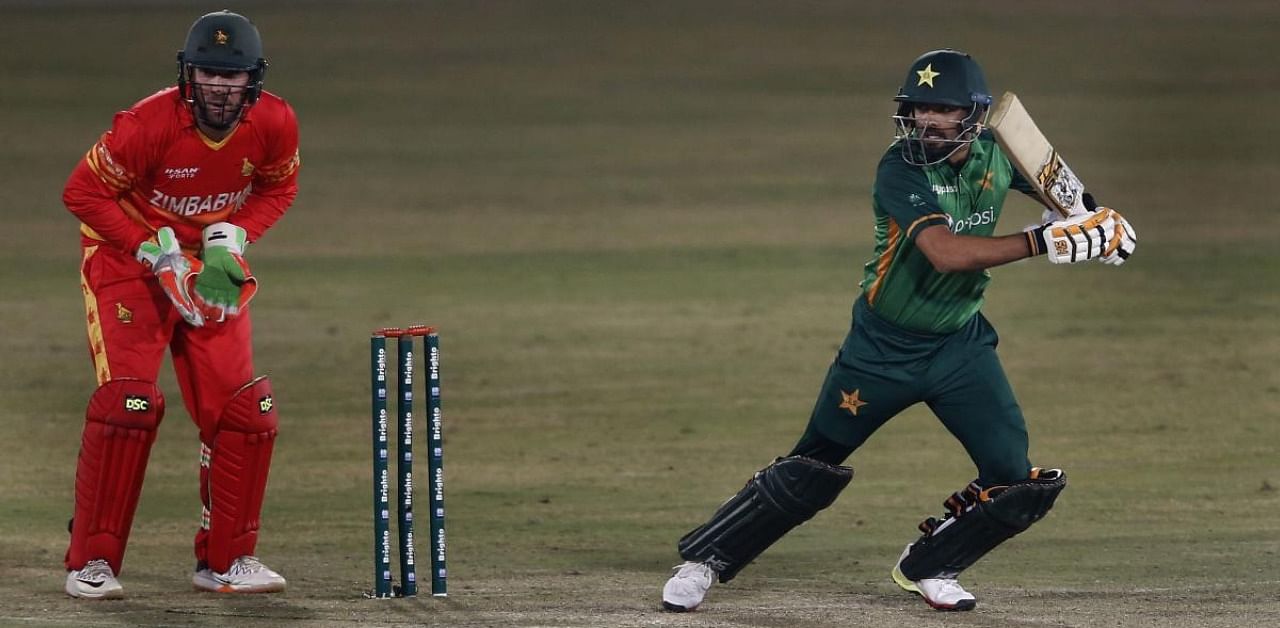 Pakistani batsman Babar Azam, right, plays a shot while Zimbabwe's wicketkeeper Brendan Taylor, watches during their 2nd one-day international cricket match at the Pindi Cricket Stadium, in Rawalpindi. Credit: AP