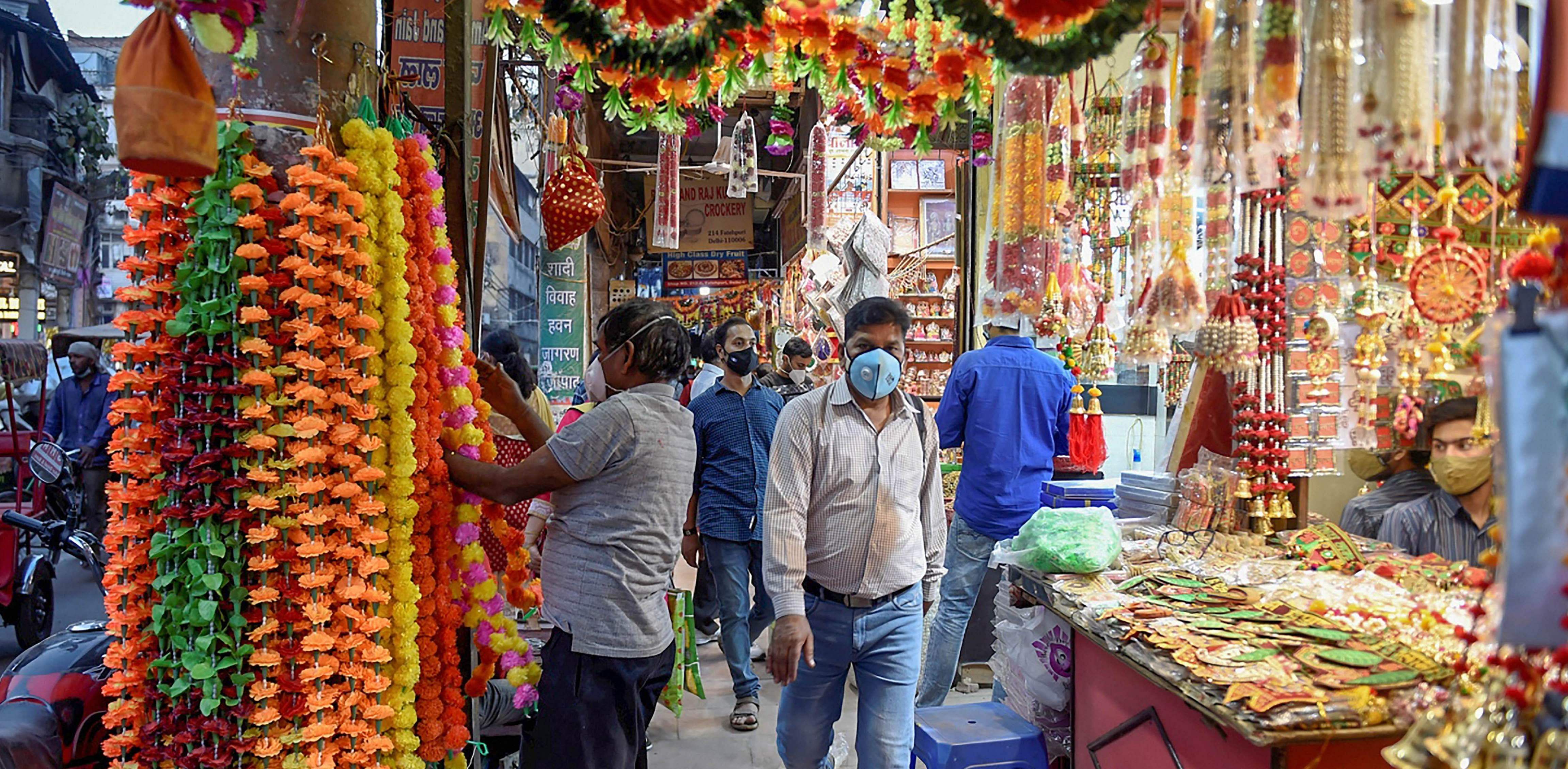 People shop decorative items at Chandni Chowk market ahead of Diwali festival, amid coronavirus pandemic, in New Delhi. Credit: PTI