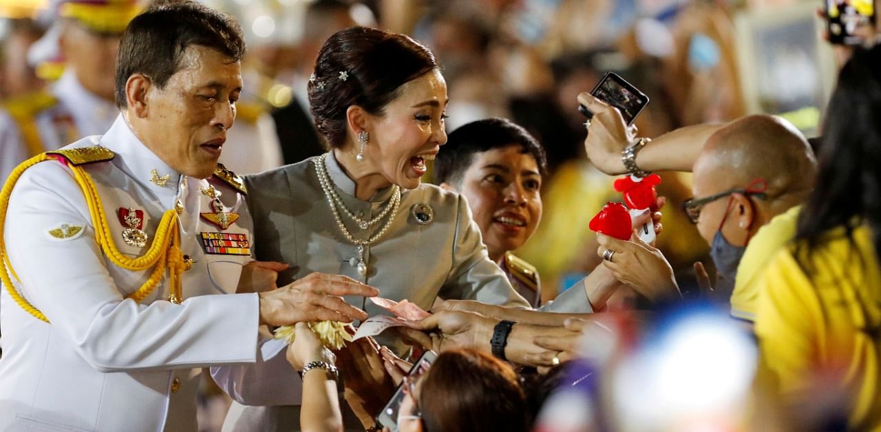 Thailand's King Maha Vajiralongkorn and Queen Suthida greet royalist supporters outside the Grand Palace in Bangkok on November 1, 2020 after presiding over a religious ceremony at a Buddhist temple inside the palace. Credit: Reuters Photo