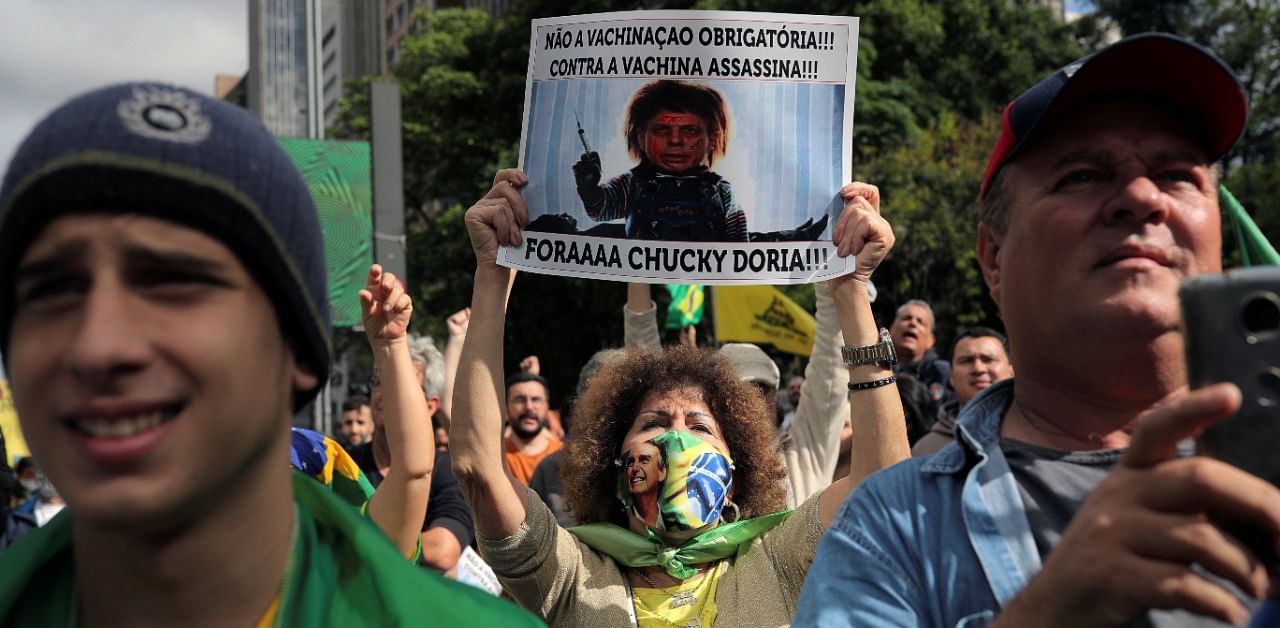 A woman holds a placard as demonstrators protest against Sao Paulo state governor Joao Doria and China's Sinovac potential coronavirus disease vaccine in Sao Paulo, Brazil. Credit: Reuters Photo