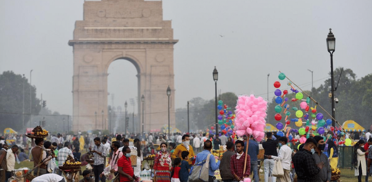 People at Rajpath lawns in the backdrop of India Gate, amid the coronavirus pandemic, in New Delhi. Credit: PTI