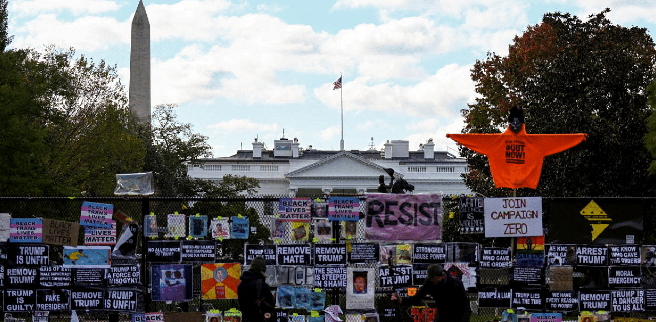  White House seen behind a fence and protest posters the day before the US presidential election in Washington, DC, US. Credit: Reuters Photo