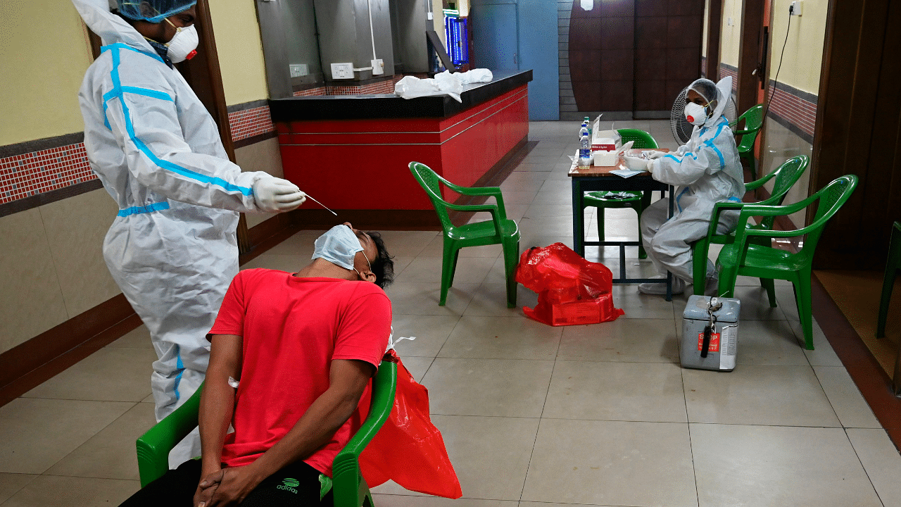 A health worker performs a swab test on a man at a mobile Covid-19 Coronavirus testing clinic in Kolkata. Credits: AFP Photo