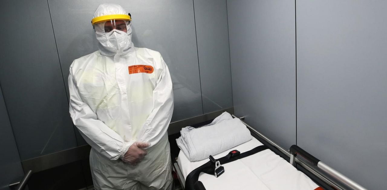 A member of the medical personnel of NAAB Ambulance company wearing personal protective equipment (PPE) waits in a lift designated for COVID-19 patients at the Clinic Europe amid the coronavirus disease (COVID-19) outbreak in Brussels. Credit: Reuters