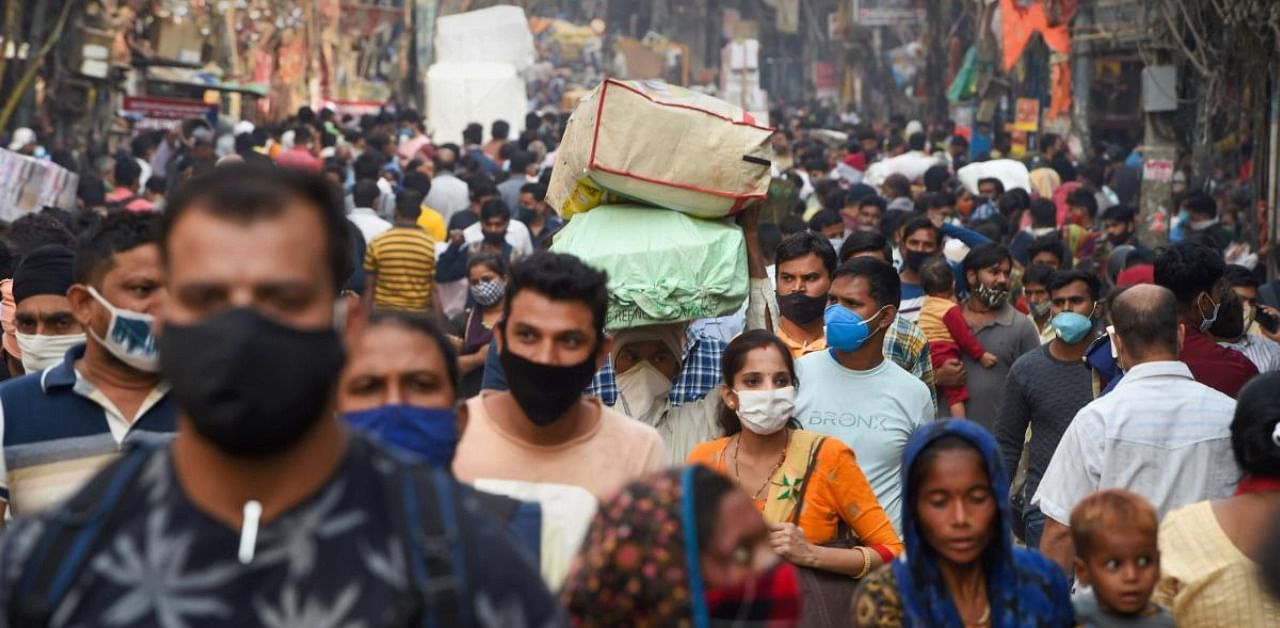 People, flouting social distancing norms, visit a crowded Sadar Bazar market during the festive season, amid the ongoing coronavirus pandemic, in New Delhi, Monday, Nov. 2, 2020. Credit: PTI Photo