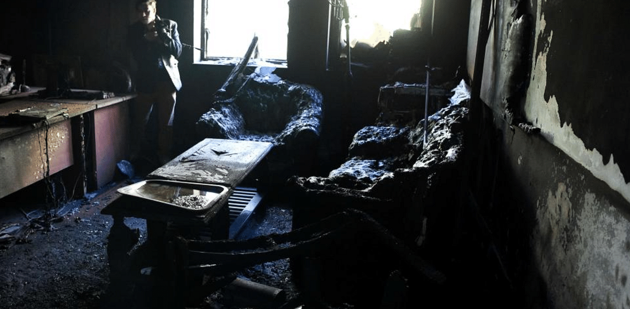 A photographer takes photos inside a burned office of the National Legal Training center, a day after gunmen stormed Kabul university in Kabul on November 3, 2020. Credit: AFP Photo