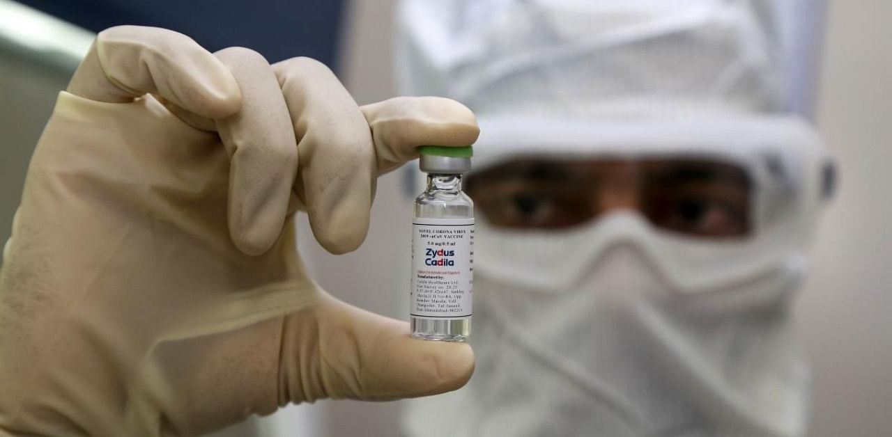 Zydus Cadila pharmaceutical company, a pharmaceutics worker shows a shot of a vaccine developed by Zydus Cadila to treat the Covid-19. Credit: AFP