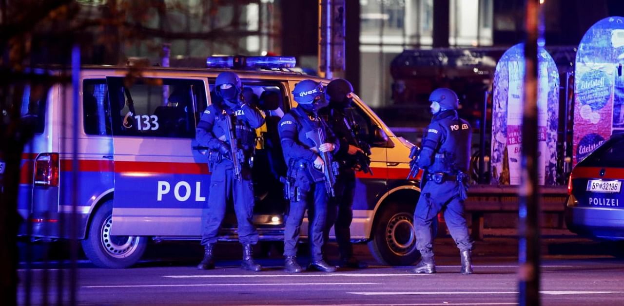 Police officers stand guard on a street after exchanges of gunfire in Vienna. Credit: Reuters Photo