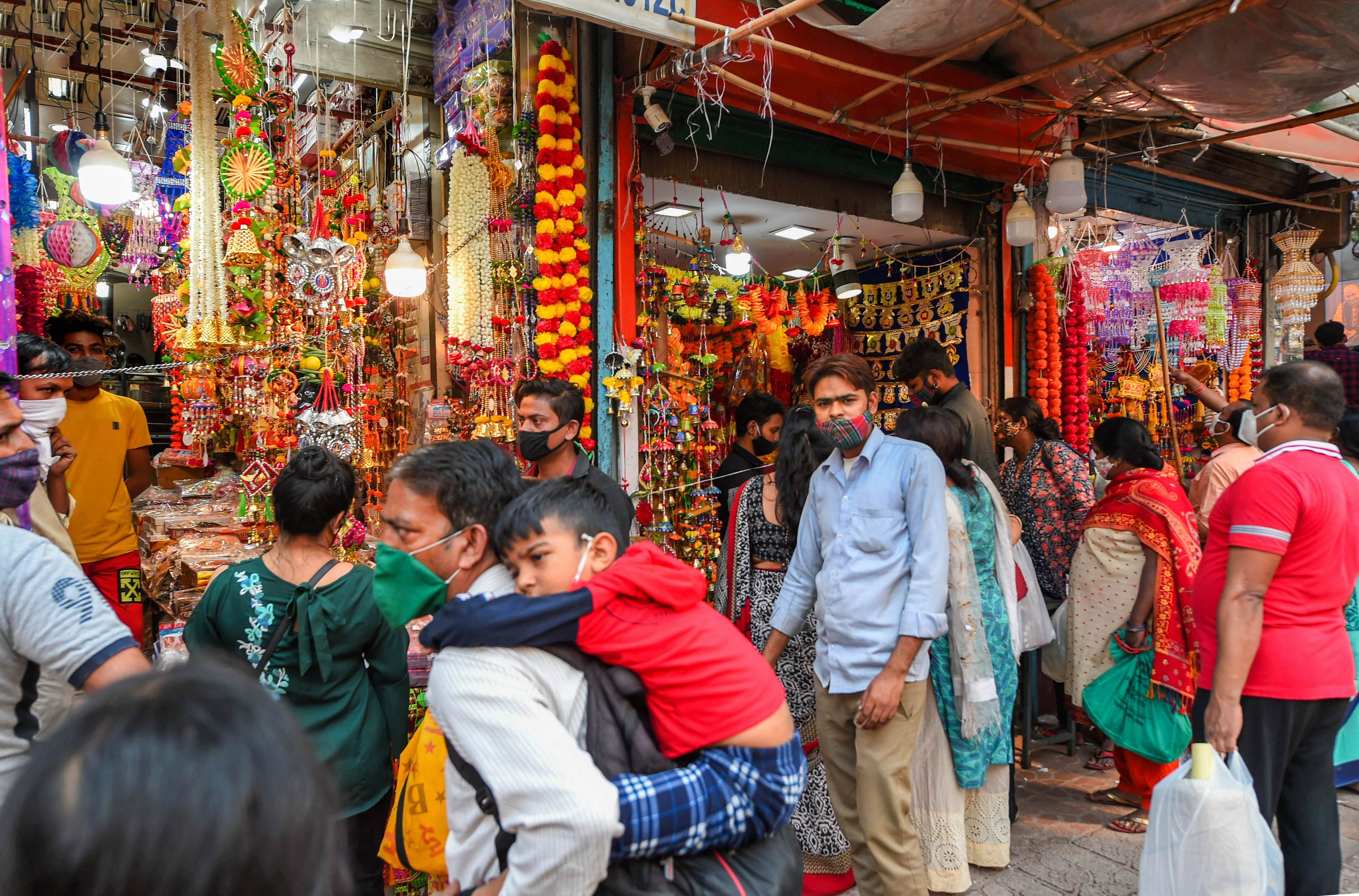 People buy commodities during the festive season, amid the coronavirus pandemic, at Sadar Bazaar in New Delhi. Credits: PTI Photo