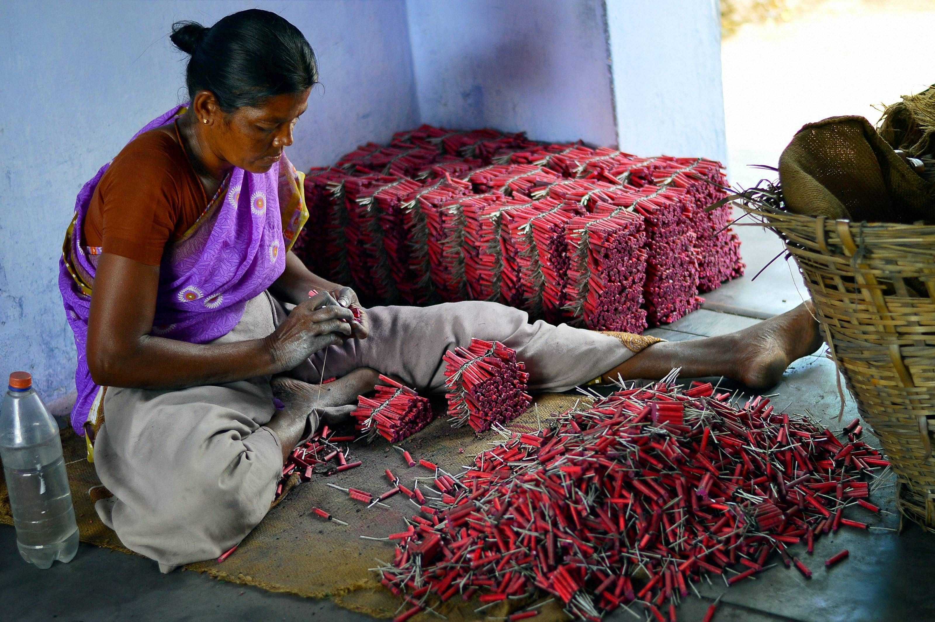 A woman employee making crackers at a factory in Sivakasi district in Tamil Nadu. Credit: PTI File Photo