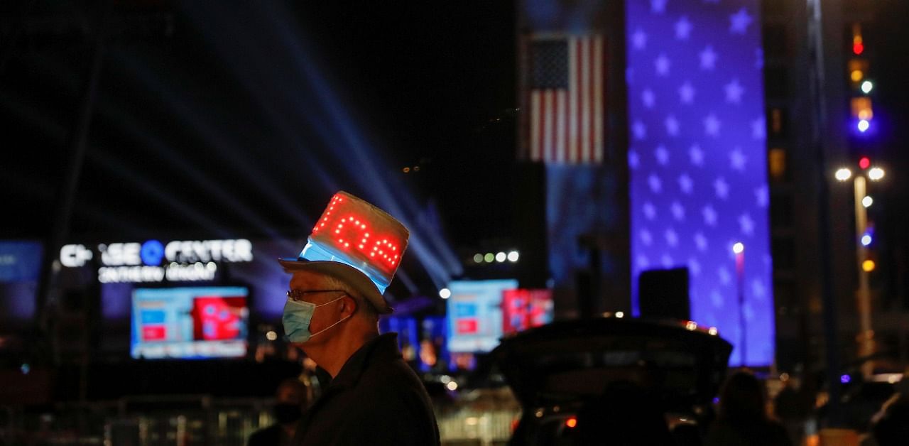 Biden supporter wears a hat with lights reading "JOE" in the parking lot where  Joe Biden will hold his 2020 US presidential election night event as a drive-in rally because of Covid-19, in Wilmington, Delaware. Credit: Reuters Photo