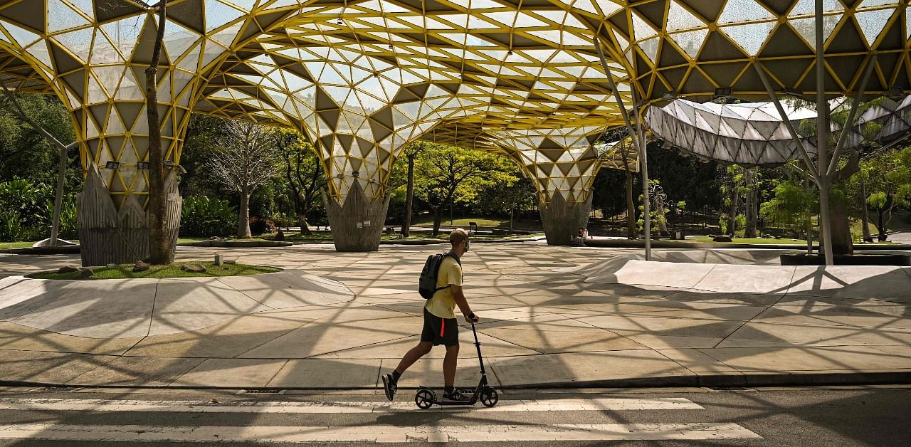 A man rides a scooter at the empty Perdana Botanical Gardens in Kuala Lumpur on October 30, 2020. Credit: AFP Photo