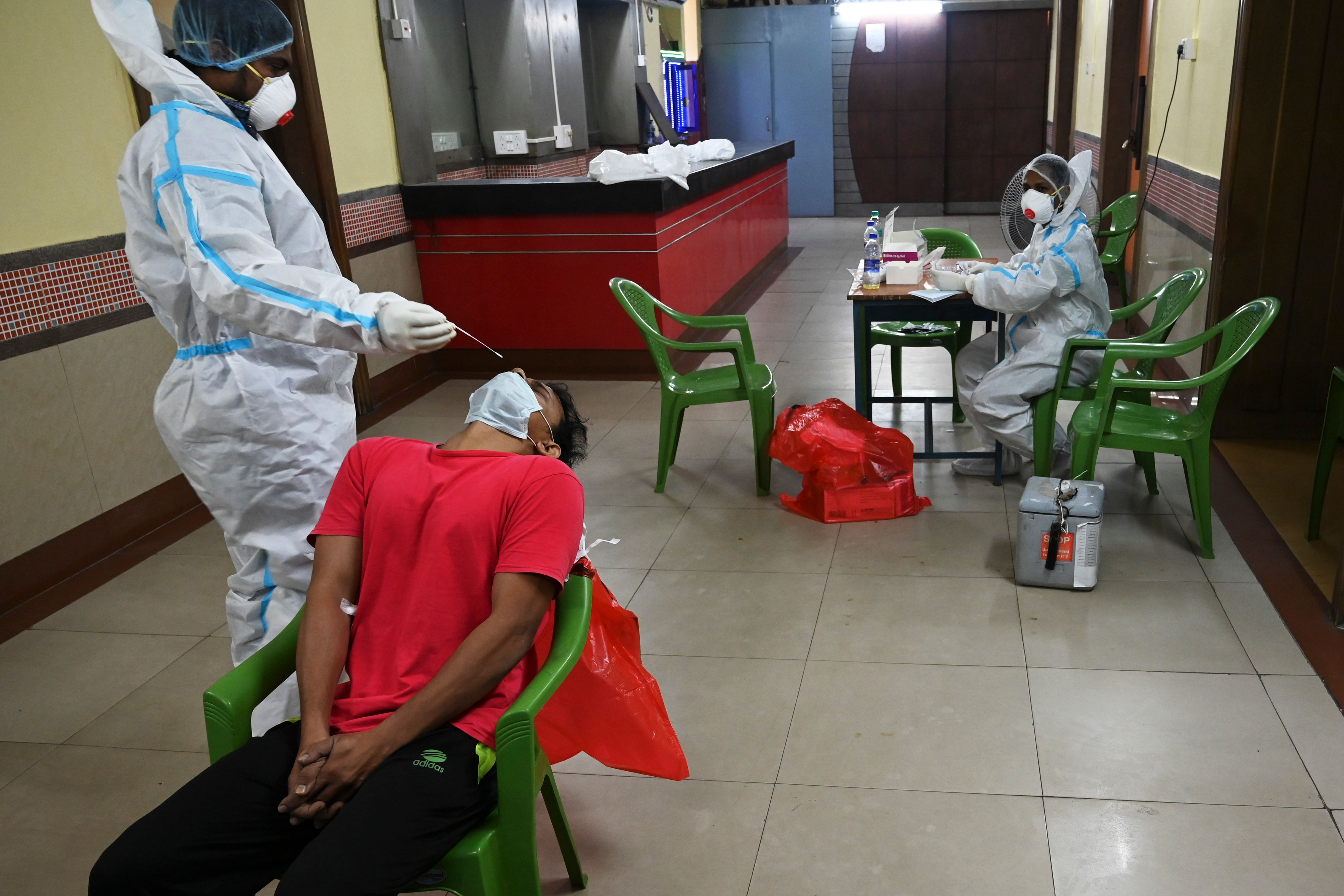 A health worker performs a swab test on a man at a mobile Covid-19 Coronavirus testing clinic in Kolkata. Credits: AFP Photo