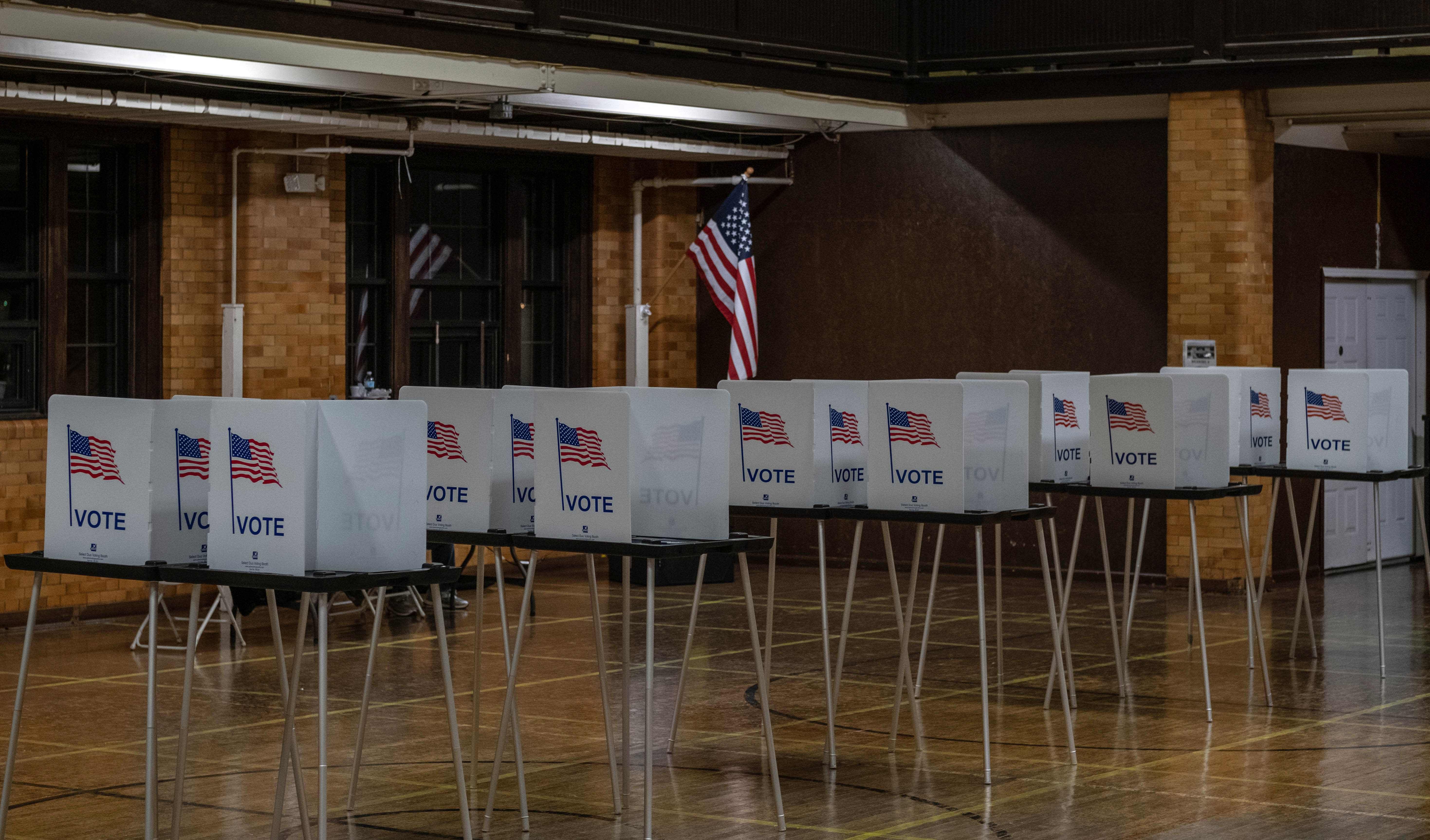 Empty voting booths are seen in Flint, Michigan at the Berston Fieldhouse polling place on November 3, 2020. - The US is voting Tuesday in an election amounting to a referendum on Donald Trump's uniquely brash and bruising presidency, which Democratic opponent and frontrunner Joe Biden urged Americans to end to restore "our democracy." Credit: AFP