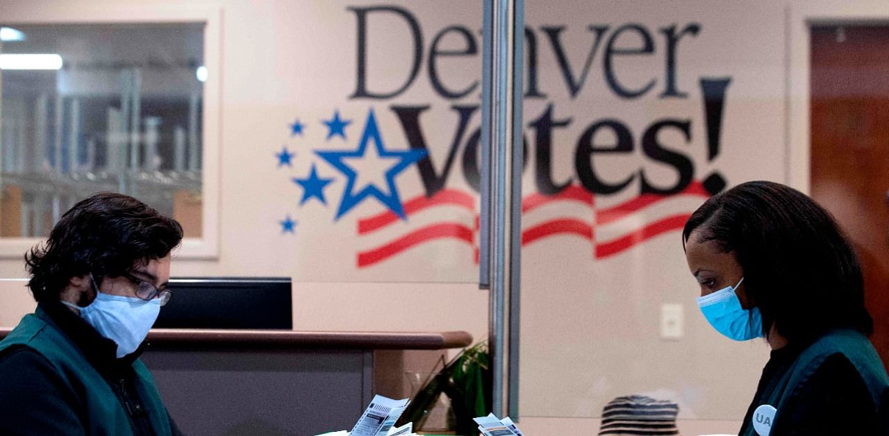 Poll workers review voter ballots at the Denver Elections Division headquarters in Denver, Colorado on November 3, 2020. Credit: AFP Photo