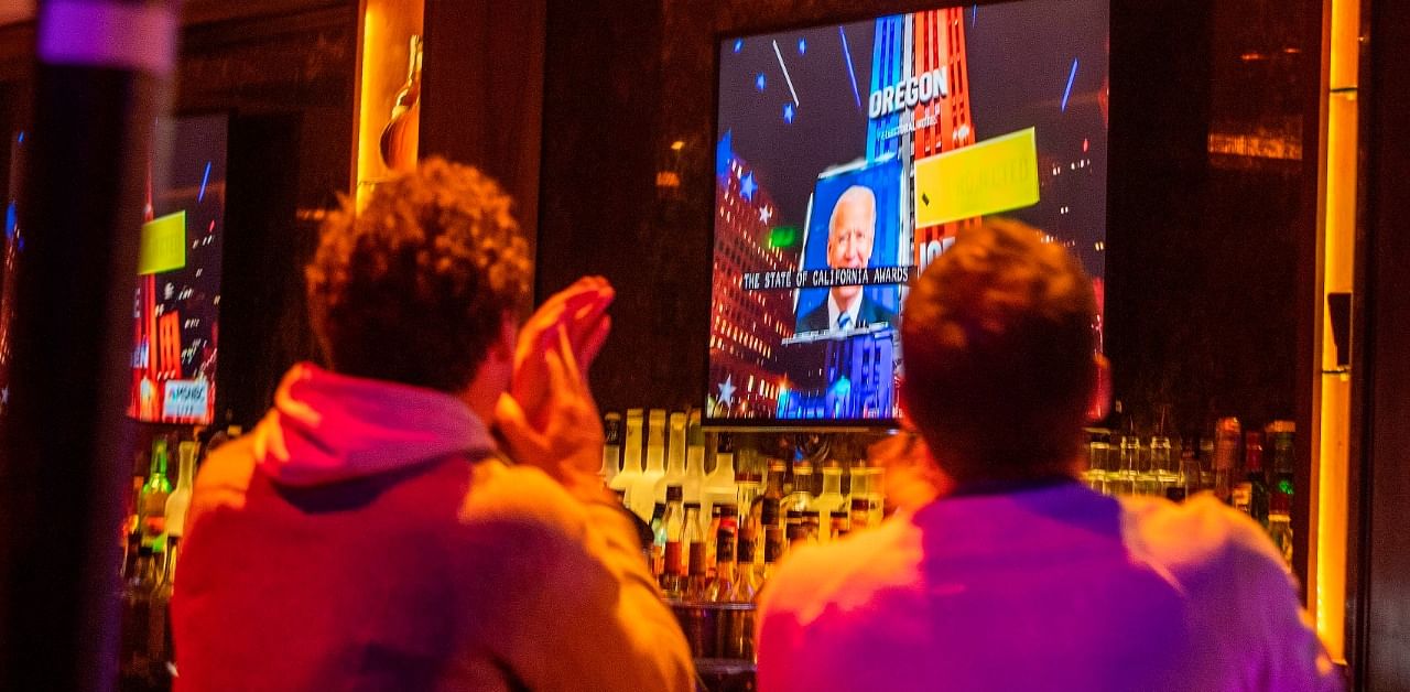 People react to the state of California staying a Democrat state during the election night at the Abbey Food & Bar in West Hollywood, California on November 3, 2020. Credit: AFP Photo