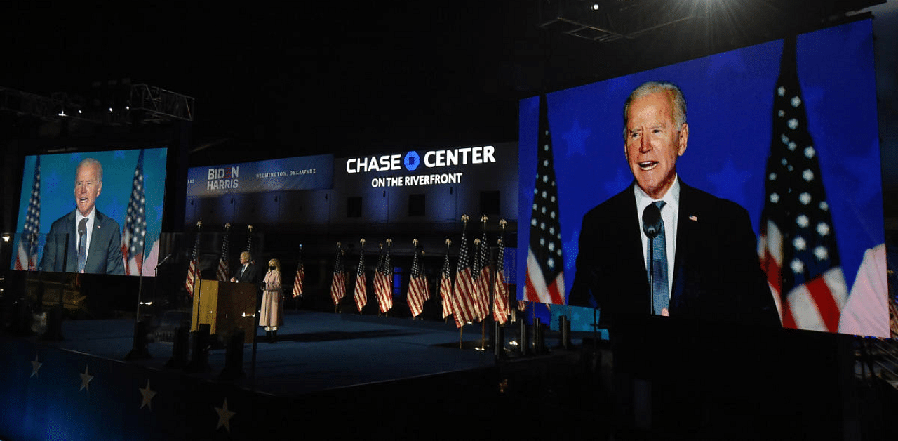 Democratic presidential nominee Joe Biden (L) and wife Jill Biden arrive onstage to address supporters during election night at the Chase Center in Wilmington, Delaware. Credit: AFP Photo