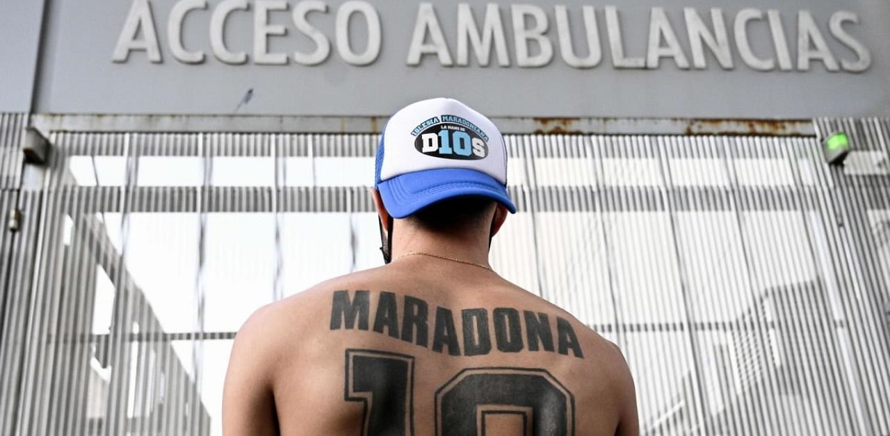 A supporter of Maradona outside the hospital where he underwent brain surgery. Credit: AFP Photo
