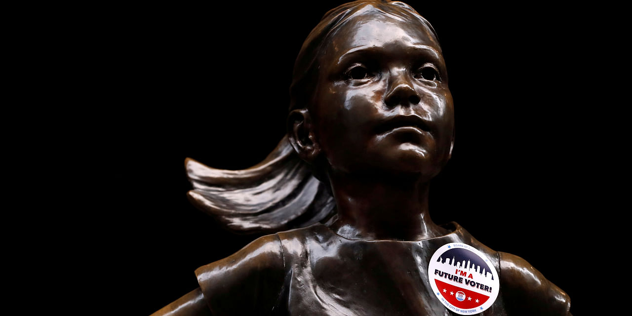 "I'm a Future Voter" sticker is seen on the Fearless Girl statue on Election Day outside the New York Stock Exchange (NYSE), in Manhattan, New York City, New York, US. Credit: REUTERS