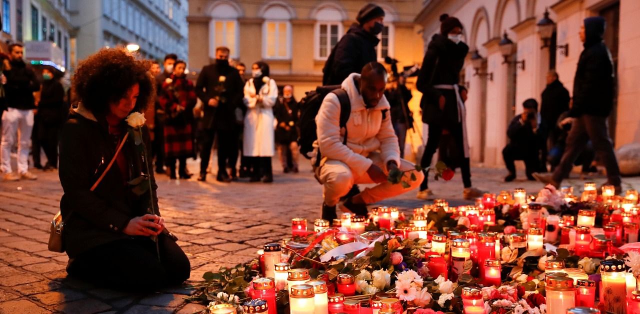 People pay respect on the site of a gun attack in Vienna, Austria. Credit: Reuters Photo