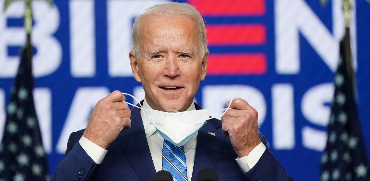 Democratic US presidential nominee Joe Biden removes his face mask to speak about the 2020 US presidential election results during an appearance in Wilmington, Delaware. Credit: Reuters Photo